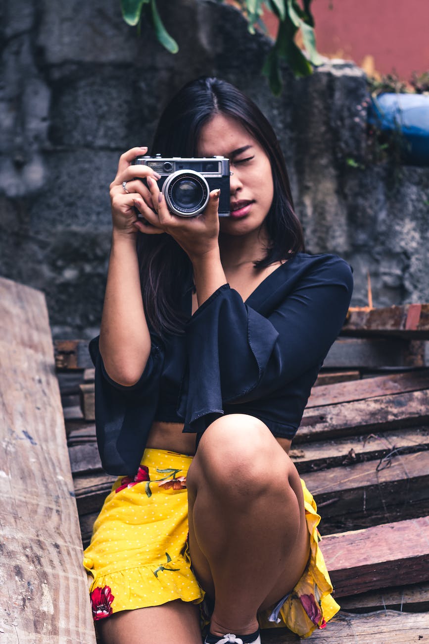 woman taking photo using slr camera