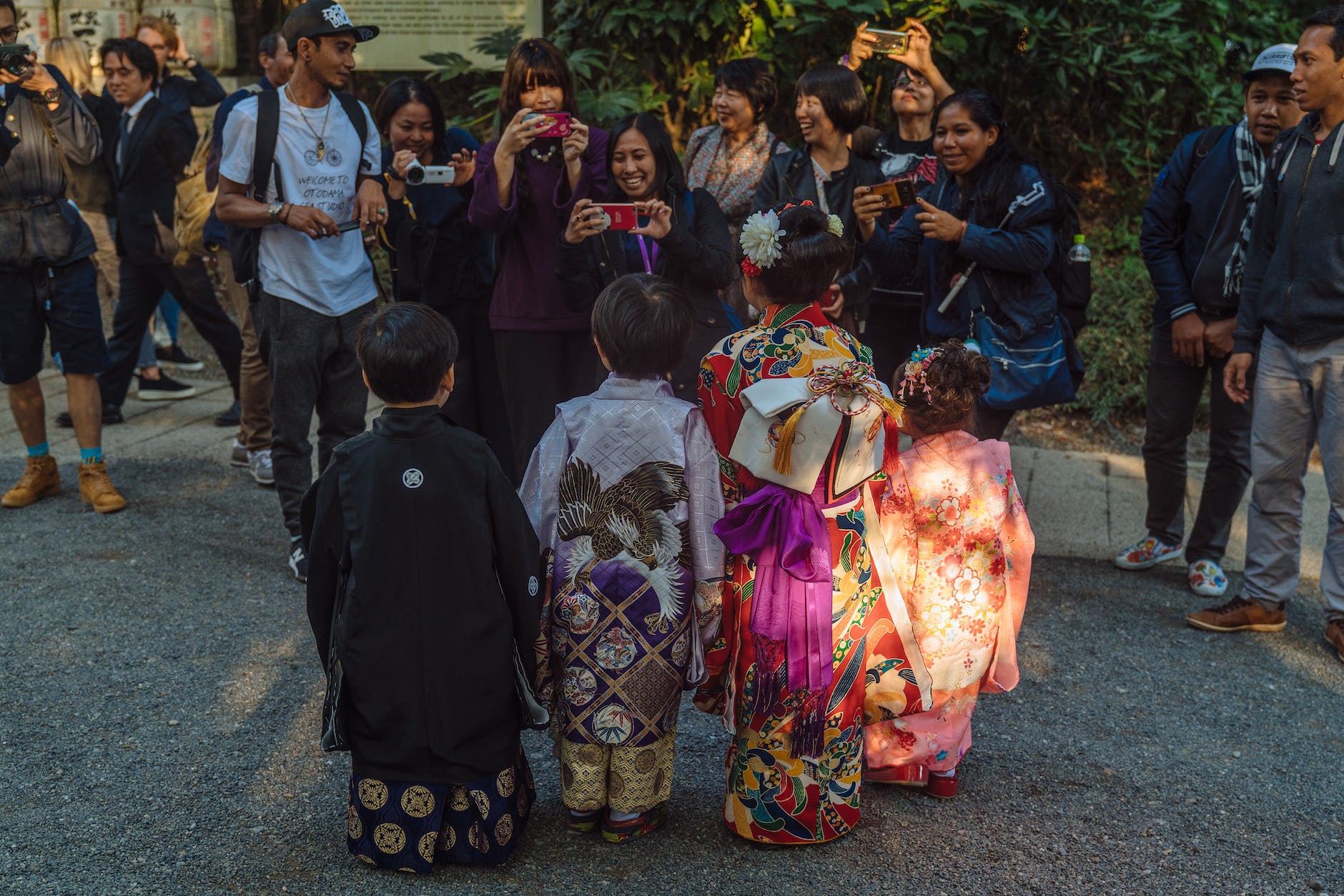 people taking photos of the kids wearing kimonos